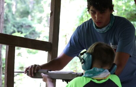 JC teaches safety on the range to a boy