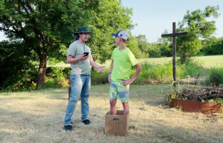 Josh and Matt perform skit Sin Box by the fire pit